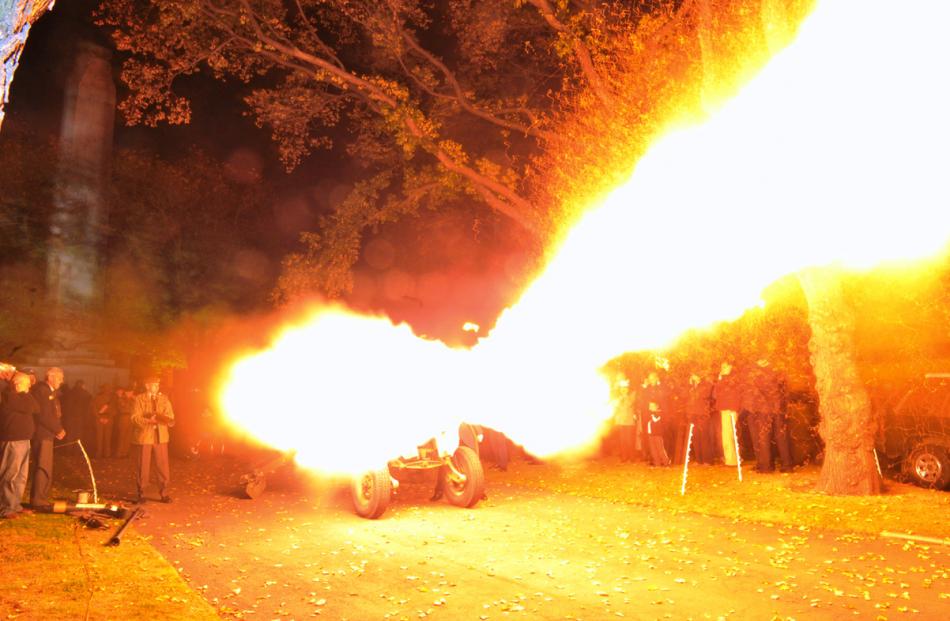 A 105mm pack howitzer turns the night into daylight signalling the start of the service.