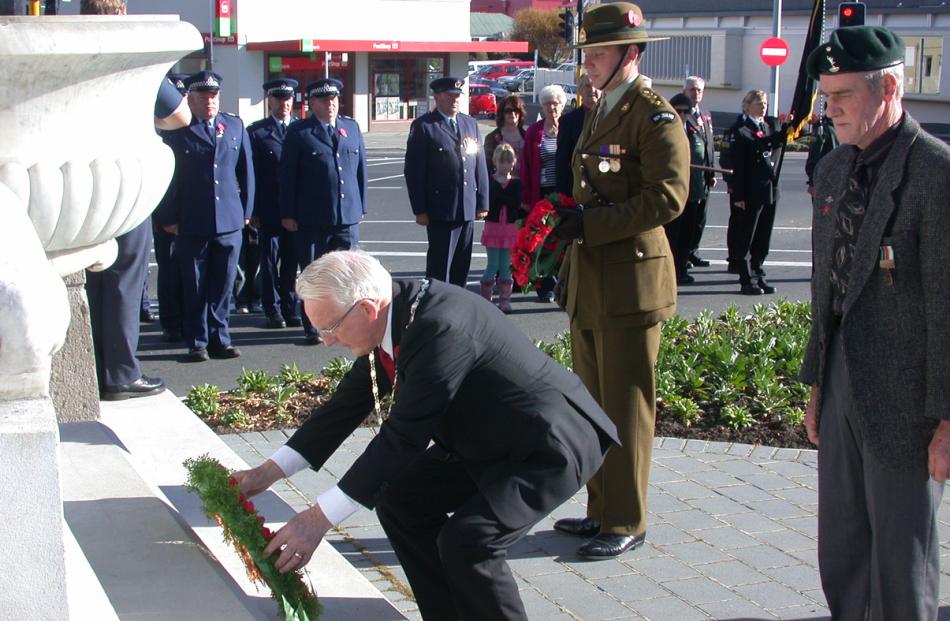 Waitaki Mayor Alex Familton lays a wreath at the Boer War monument, along with (from left) NZ...