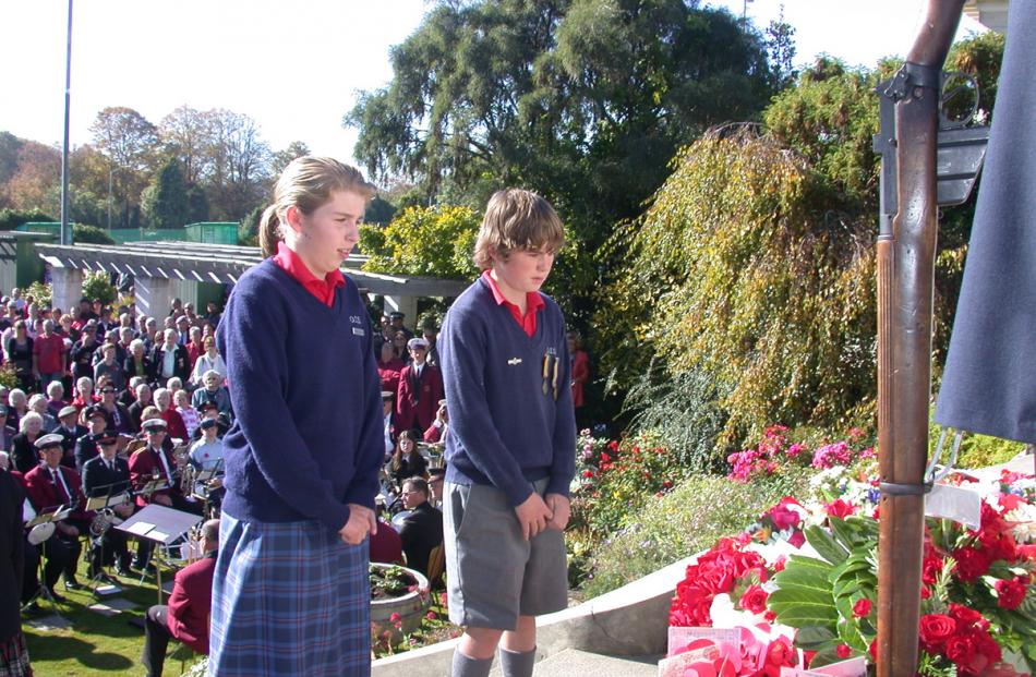 Ella Hitchcock, 12 (left), and James Scott, 13, lay a wreath on behalf of Oamaru Intermediate...