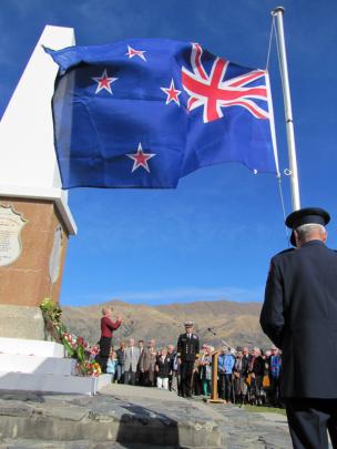 Jackie Hamilton, of Cromwell, plays the Last Post, while Queenstown Lakes deputy mayor Commander...