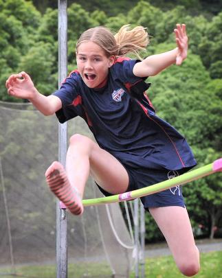 Kavanagh College’s Anamika Jones (13) attempts to clear the bar in the girls under-13 high jump.
