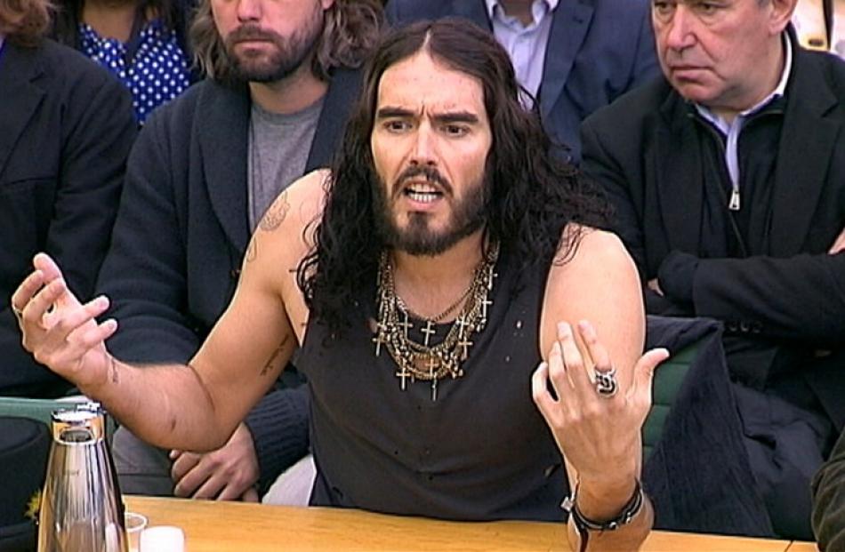 Actor Russell Brand adresses the House of Commons Home Affairs Committee in London, talking about...