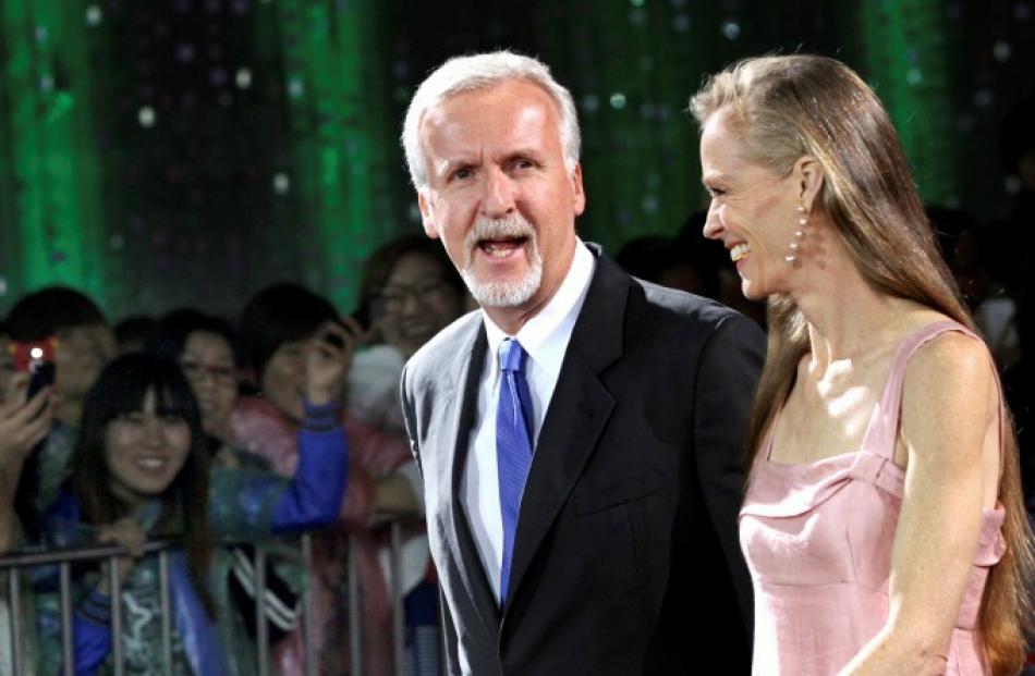 Canadian film director James Cameron walks with his wife Suzy Amis on the red carpet during the...