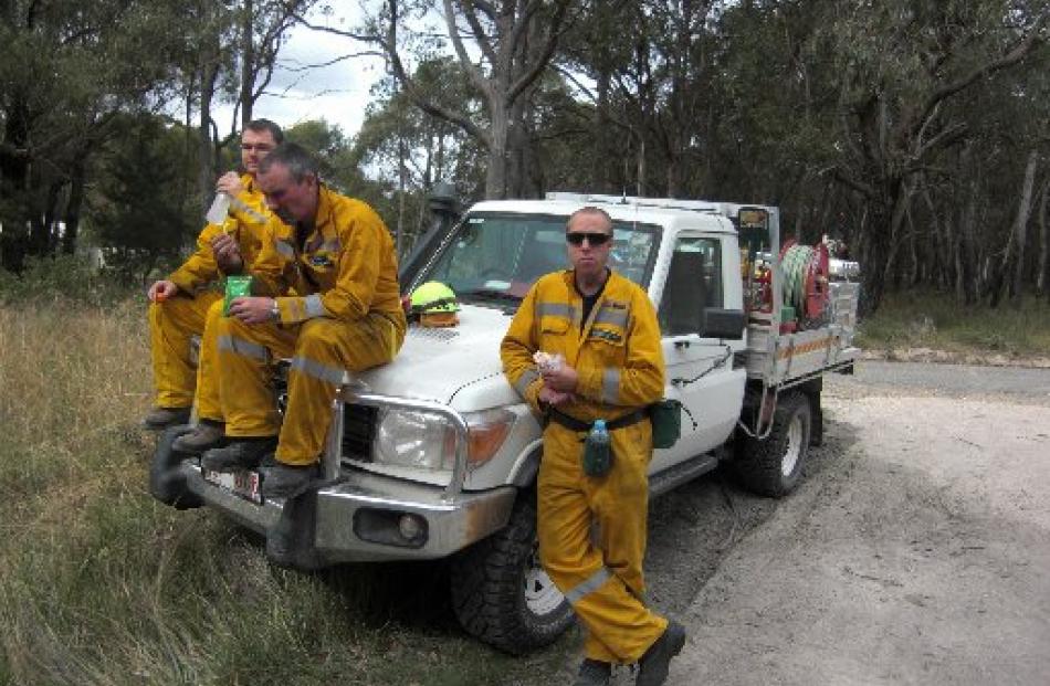 Doc rural firefighters Gavin Udy, Shayne Pearce and Glenn Fyfe take a break from a controlled...