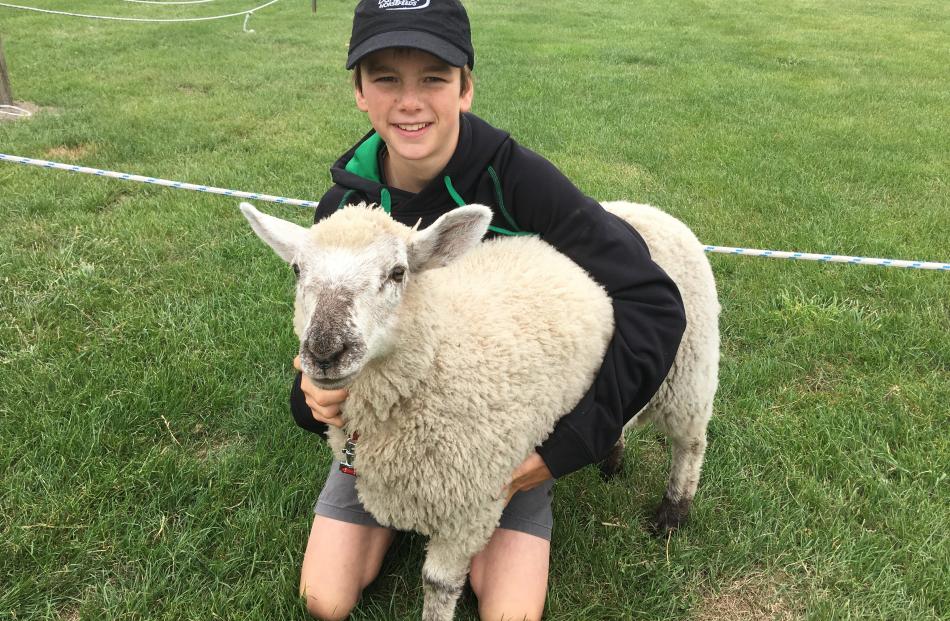 Senior lamb champion winner pupil Toby Benison (13), of Springston School, hugs his 14-week-old...