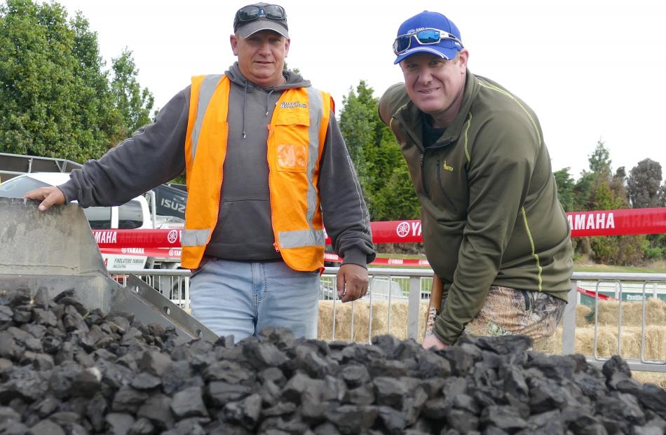 Marc Latta (left) and Ben Eatwell, both of Balclutha, man the Black Gold Classic coal shovelling...