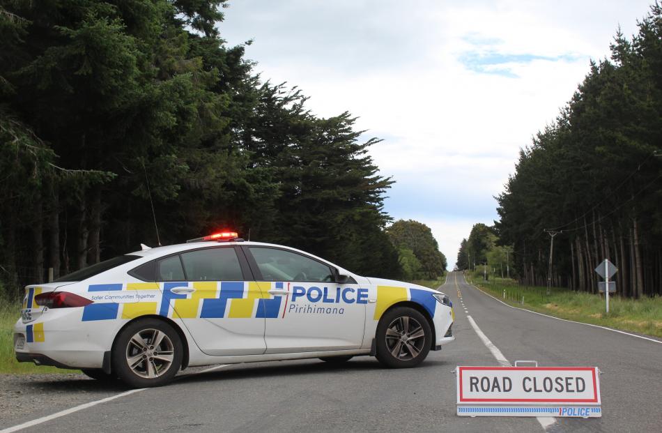 Police block a road after a falling tree brought down powerlines near Invercargill. PHOTO: ABBEY...
