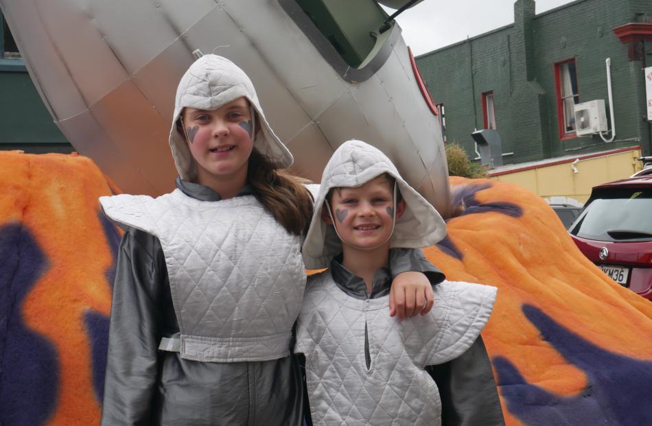 Friends Charlotte Henderson (10) and Taj Morey (9) are astronauts on the space ship float.