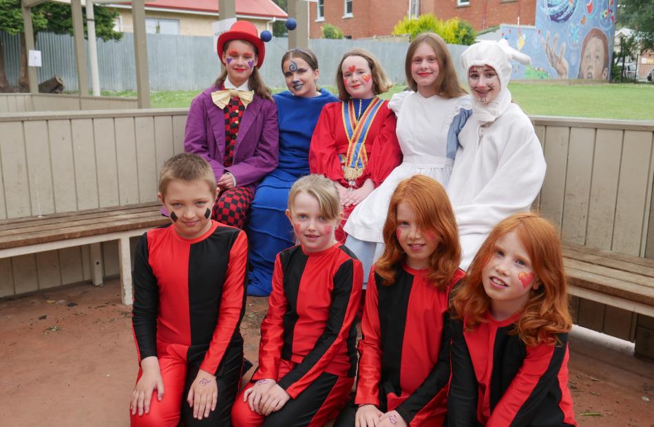 Dressed as Alice Through the Looking Glass characters ready for the Santa Parade are (back from...