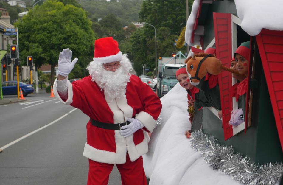 Santa Claus and his elves prepare for the start of the parade.

