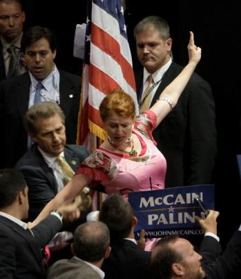 An unidentified protestor is pulled away during Palin's speech. Photo Paul Sancya/AP.