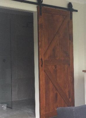 A wooden imitation stable door features in a bathroom at The Stables.



