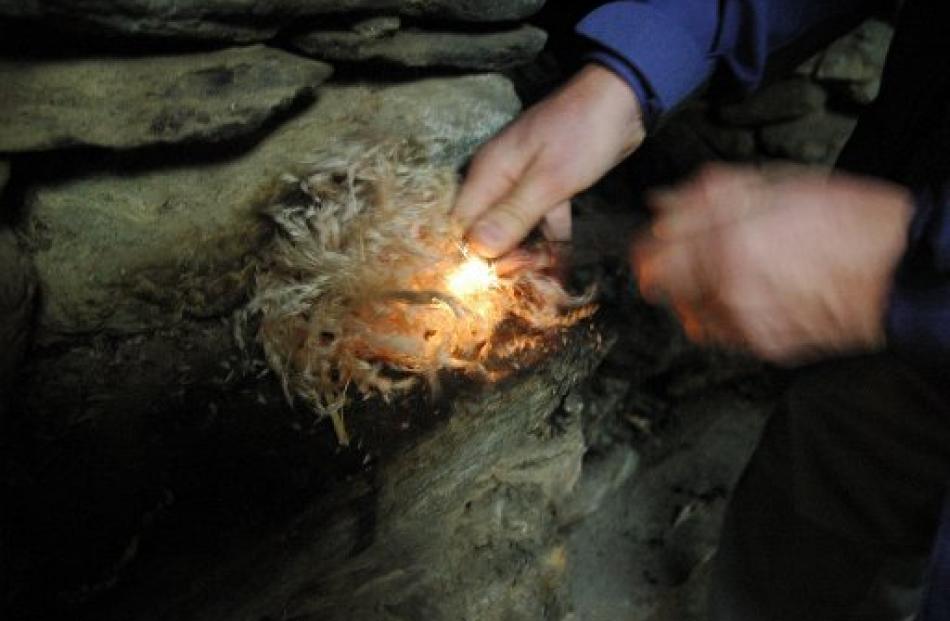 Starting a blaze with the help of a magnesium fire-steel and some toi toi.