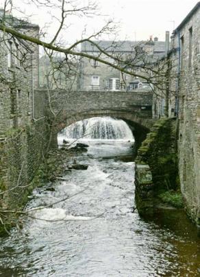 A picture-perfect scene of a waterfall in a village in the Yorkshire Dales.