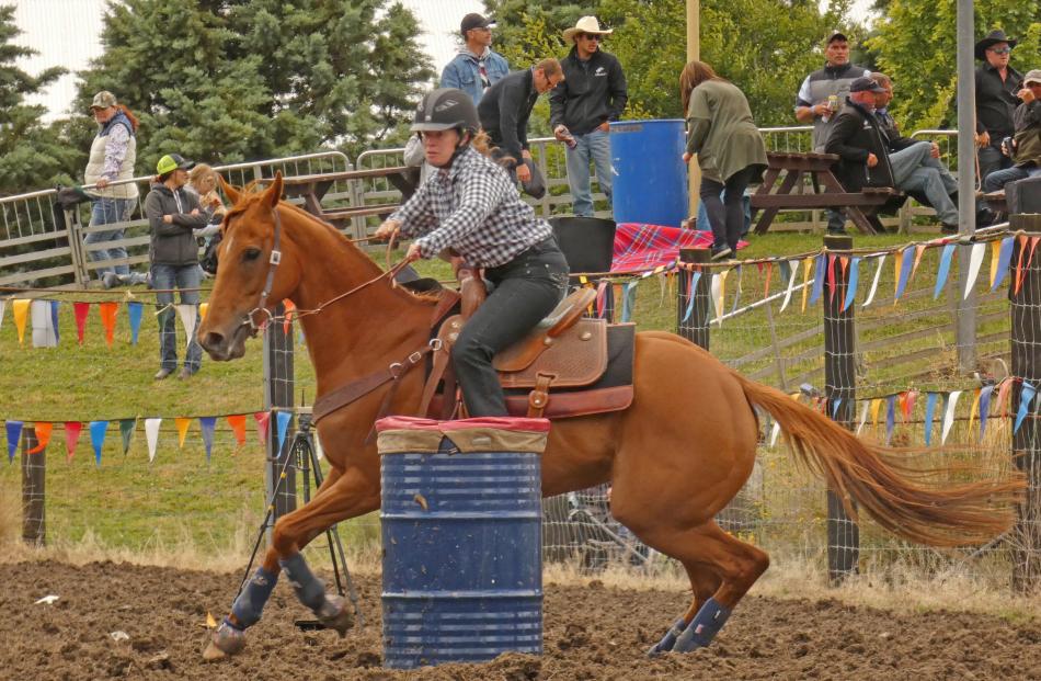 Natalie De Caro, of Lake Hawea, rounds a barrel in the Millers Flat Rodeo second division barrel...