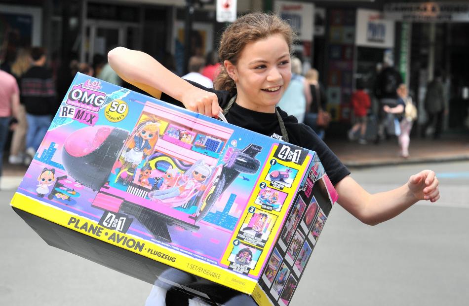 Loyalty Forde (10) carries her toy bought on Boxing Day. 