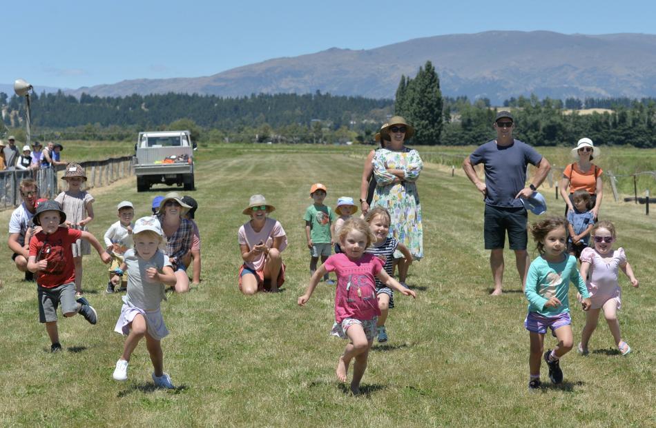 Contestants in the running of the girls under-5 race keep their focus on the much coveted bag of...