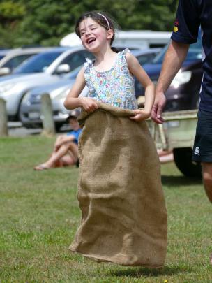 Katie Milne (5), of Invercargill, has fun in the sack race at the Papatowai Beach Carnival. PHOTO...