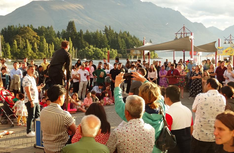 A busker draws a crowd on Queenstown’s waterfront. PHOTO: GUY WILLIAMS