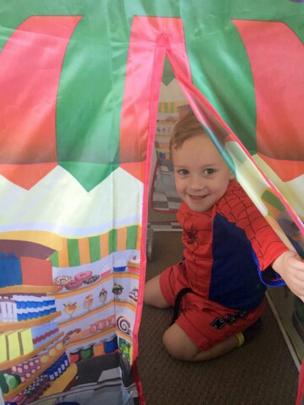 Samuel MacKenzie (2), of Invercargill, peeks out of the tent his grandmother gave him for...