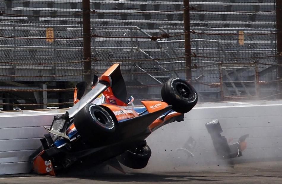 Chip Ganassi driver Charlie Kimball crashes into the first turn wall during practice for the...