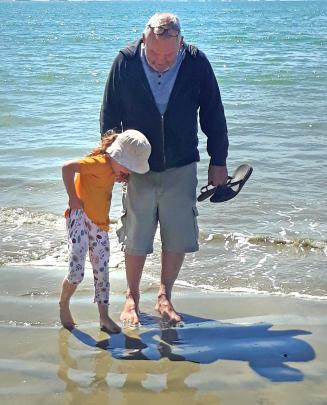 Kevin Hellyer and granddaughter Estelle Ross (4) paddle in the sea at Taramea Bay, Riverton....