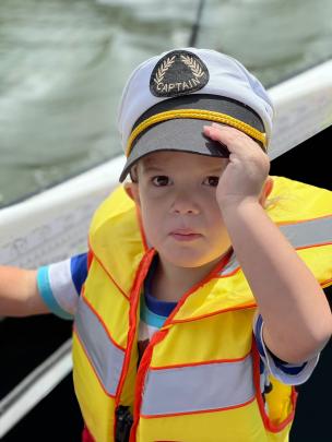 Arlo Condon (2) is boat captain on the Taieri River on December 27. PHOTO: KRISTAL CONDON