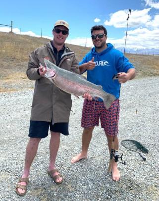 Hamish Hendry (24) shows off the rainbow trout he caught at Tekapo on Boxing Day with help from...