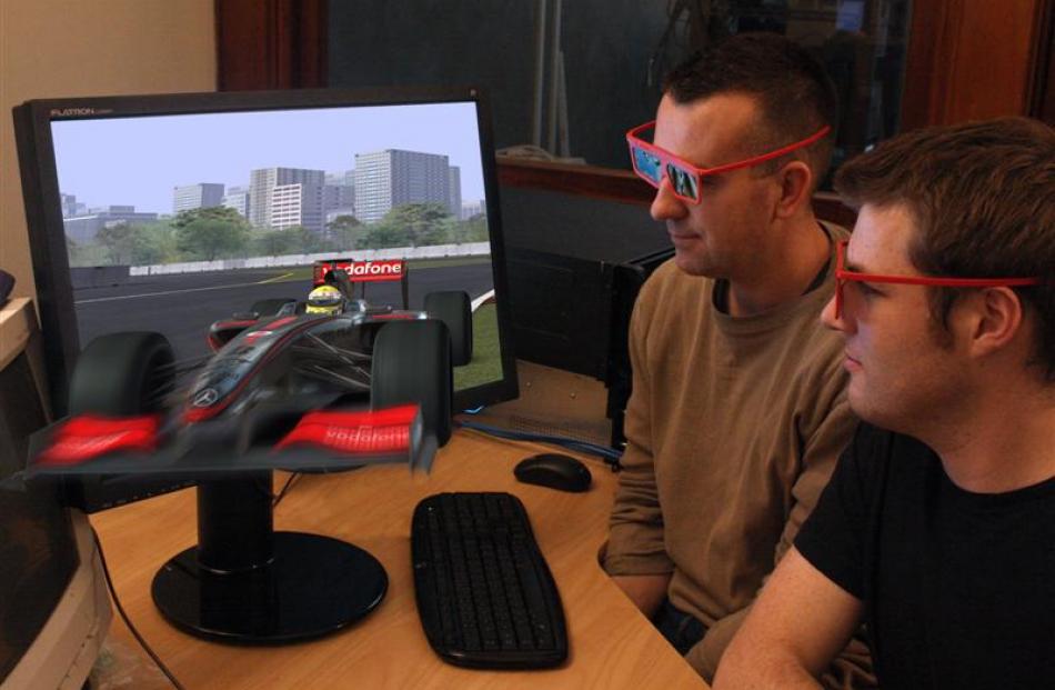Lead software developer Chris Haig tests a Formula One 3-D application.
