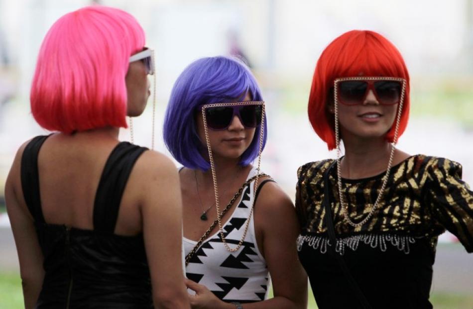 Fans of singer Lady Gaga stand in line as they wait to enter the venue for her 'Born This Way...