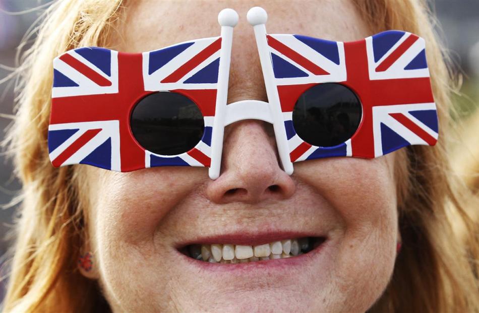 A woman wears Union Flag sunglasses in London .  REUTERS/Luke MacGregor