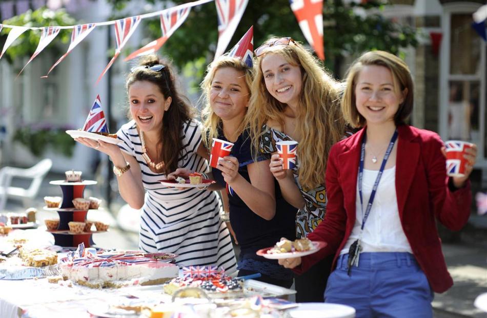 People pose at a street party in Fulham, London. REUTERS/Ki Price