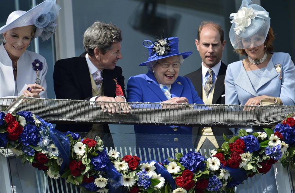 Queen Elizabeth smiles after the Epsom Derby horse race at at the launch of four days of...