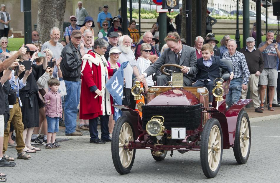 Gary Winter and son Braxton (7) lead the cars and motorcycles as they embark on the Dunedin to...