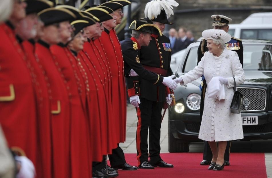 Britain's Queen Elizabeth is greeted by Chelsea Pensioners as she arrives at Chelsea Pier on the...