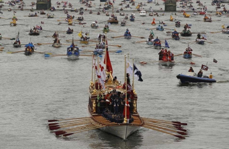 The Gloriana leads the manpowered craft towards Westminster Bridge during Queen Elizabeth's...
