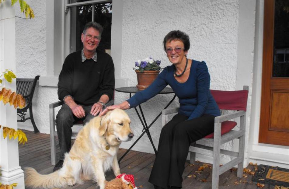 Alan and Kath Jenkins, with dog Chester, outside their historic Arrowtown home, into which they...
