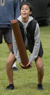 Ryleigh Makiiti (13), of Dunedin, tosses the caber at the Caledonian Society of Otago events....
