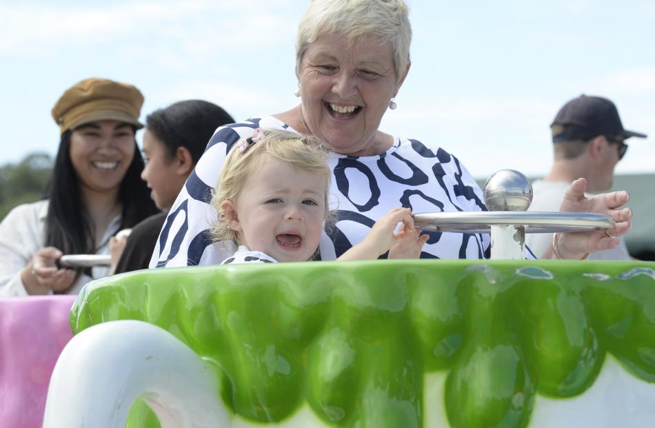 Millie McKay (2) joins her grandmother Judi McKay for a ride in a teacup.
