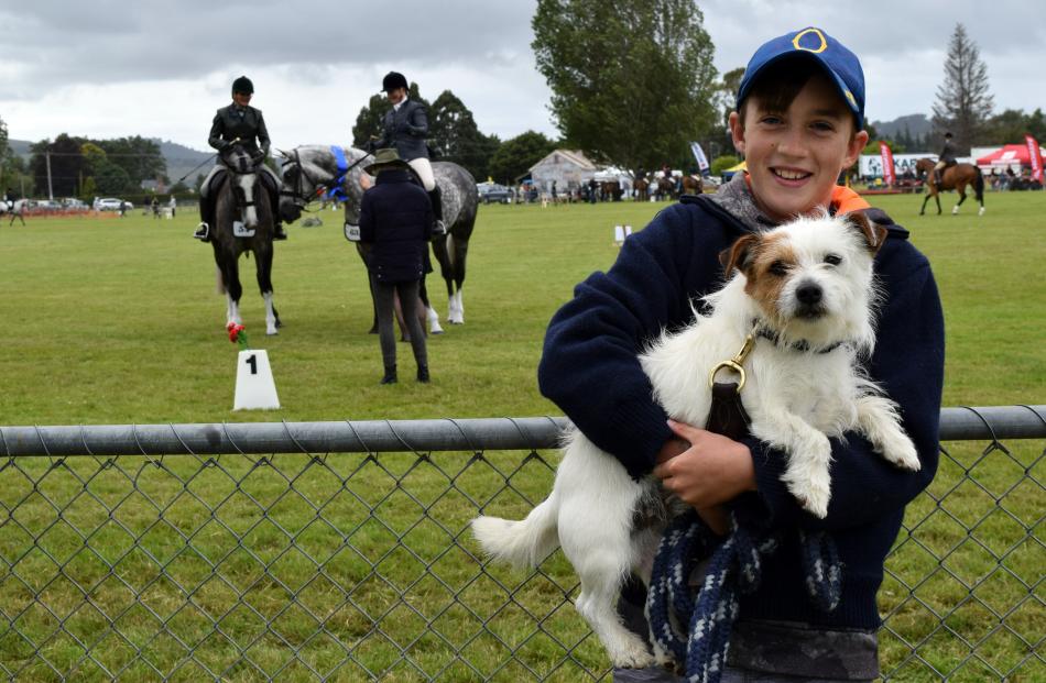 Watching an equestrian event are Charlie Nicol (10), of Lee Stream, and his Jack Russell terrier,...