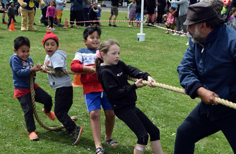 Competing in a tug-of-war are (from left) Sio Tofilau (4), Ezra Namana (5), JT Tofilau (7), Lucy...