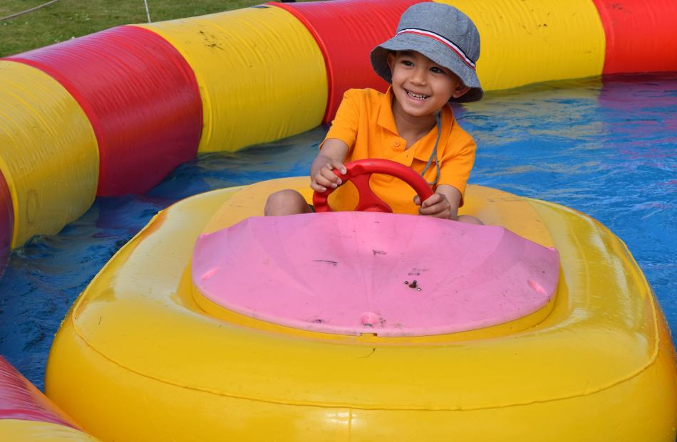 Noah Khalifa (5), of Mosgiel, drives a toy boat.

