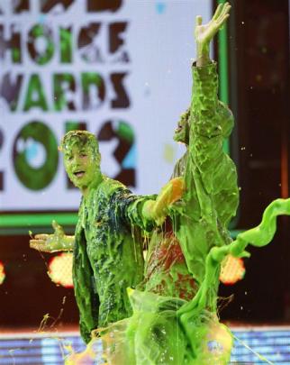 Canadian singer Justin Bieber and actor Will Smith are slimed on stage at Nickelodeon's 25th...