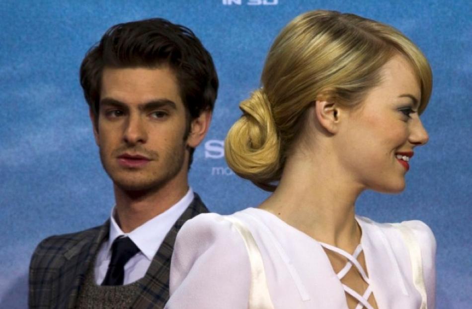Cast members Andrew Garfield and Emma Stone pose on the red carpet before the German premiere of...