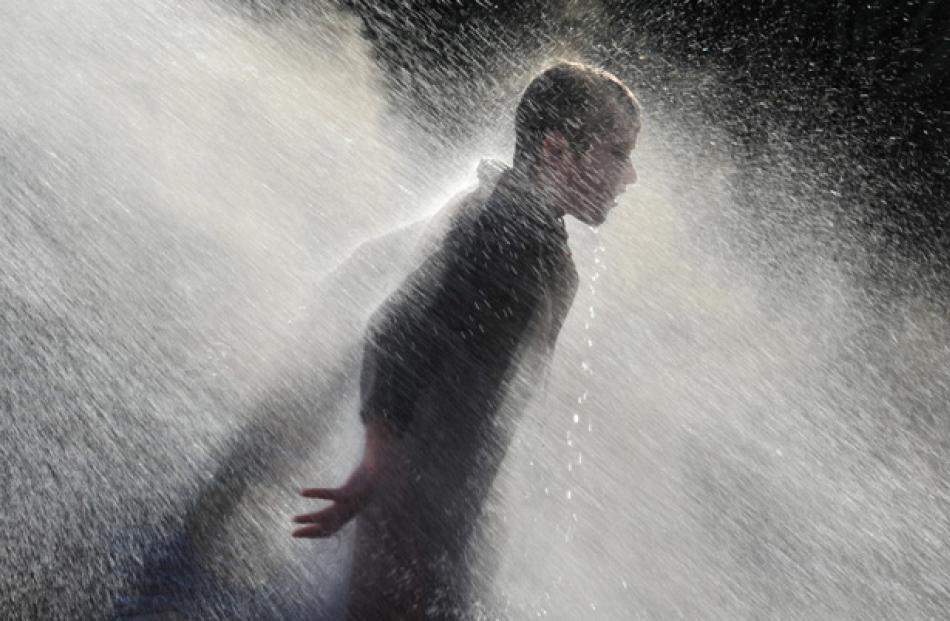 Harrison Campbell (12) enjoys a warm shower.