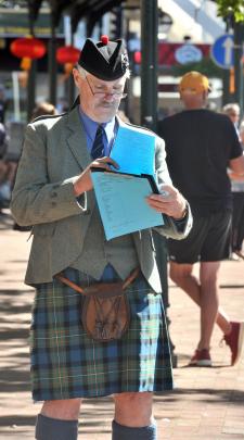 Ross Ferguson, one of the adjudicators at the Octagonal Day pipe band street march, scores the...