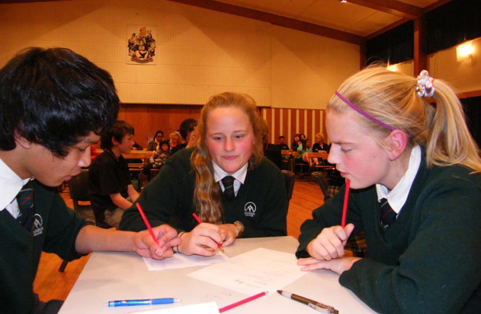 James Abella (14),  Zoey Taylor (13) and Jess Mackay (13), of Mackenzie College, decide on a word.