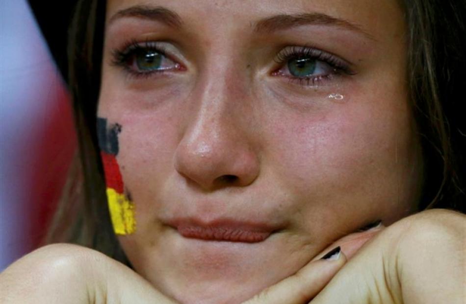 A Germany fan cries after the loss to Italy in the Euro 2012 football semi-final. REUTERS/Peter...