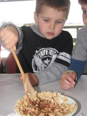 Thornton Read (5), of Queenstown, stirs the rice-bubble cake mix.