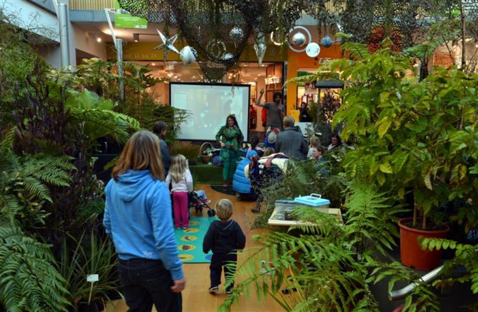 People explore the cloud forest installed at Wall Street mall yesterday.